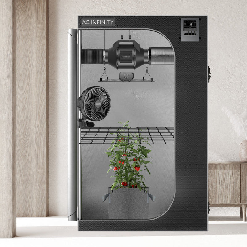 Complete 2x2 grow tent system featuring automated climate control, ventilation fan, circulation fan, and LED grow light, shown with active plant cultivation.
